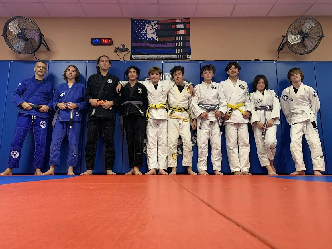 Teen Jiu-Jitsu students lined up on the mat